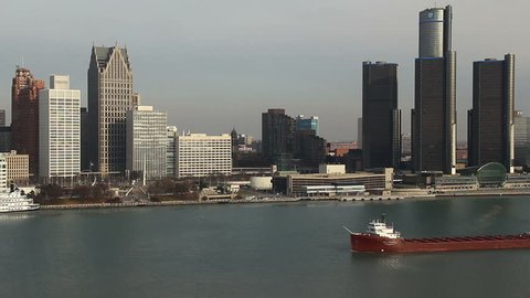 DETROIT - CIRCA NOVEMBER 2013: City skyline during a cold winter morning with a cargo ship passing, circa November 2013 in Detroit, Michigan.