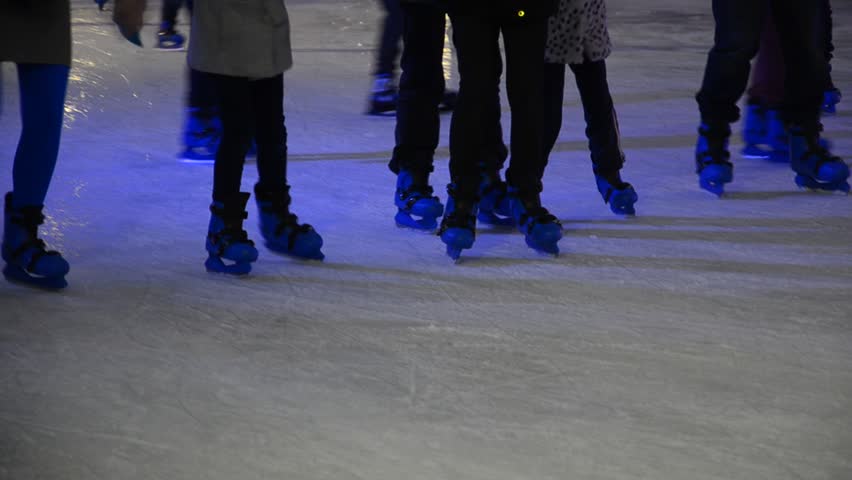 crowd of Ice skaters at a public ice skating rink, Medium Shot, Front and side