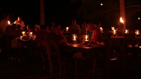 PUERTO VALLA, MEXICO - CIRCA 2012: Night outdoor candle dinner couple tropical theme Mexico. Dark night cafe near Puerto Vallarta, Jalisco, Mexico in jungle setting near a tropical beach. Romantic setting for anniversary or honeymoon.