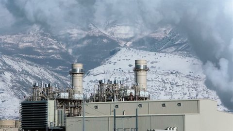 Power plant smoke stacks steam smoke winter helicopter fast timelapse HD. A natural gas turbine power station Orem, Utah. PacifiCorp Rocky Mountain Power. Produces 545 megawatts of electricity.