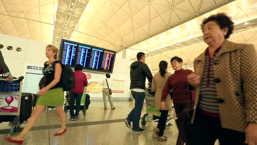 HONG KONG - DECEMBER 2: People at arrivals and departures info screens at Hong