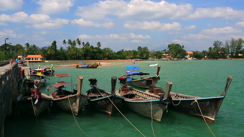 View on pier with traditional long tailed boats, Krabi, Thailand