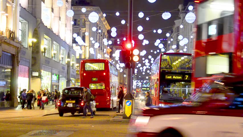 London - DEC 2013: Christmas lights and London buses at the station on busy