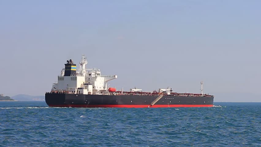 Cargo ship sailing into open sea. Oil tanker ship on route to Marmara Sea. Back