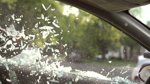 Breaking driver side car window slow motion