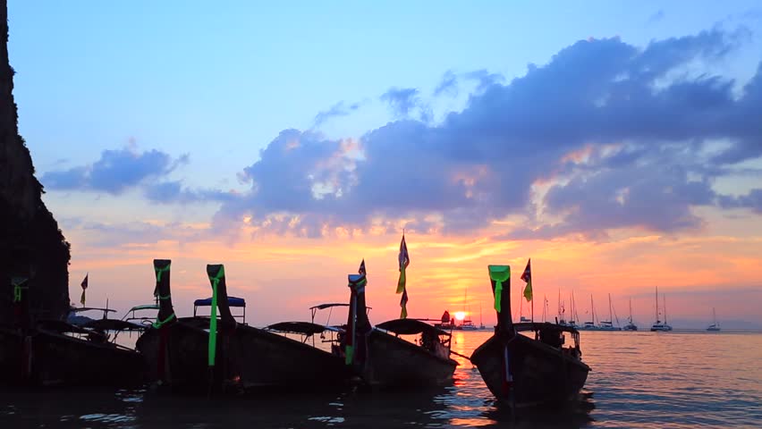 Sunset over Railay Beach, Krabi, Thailand. View on a traditional long tailed