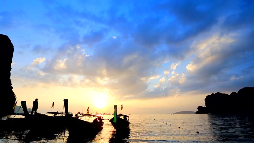 Sunset over Railay Beach, Krabi, Thailand. View on a traditional long tailed