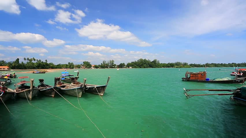 View on pier with traditional long tailed boats, Krabi, Thailand