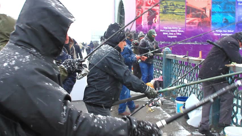ISTANBUL - JAN 31: Fishermen on Galata Bridge on January 31, 2012 in Istanbul,