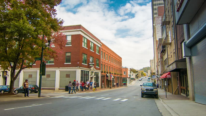 Asheville, NC City Center Streets with People Walking Past Retail Outlets in Brick Buildings.