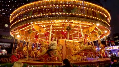 Horses Carousel in motion, in an amusement park.
