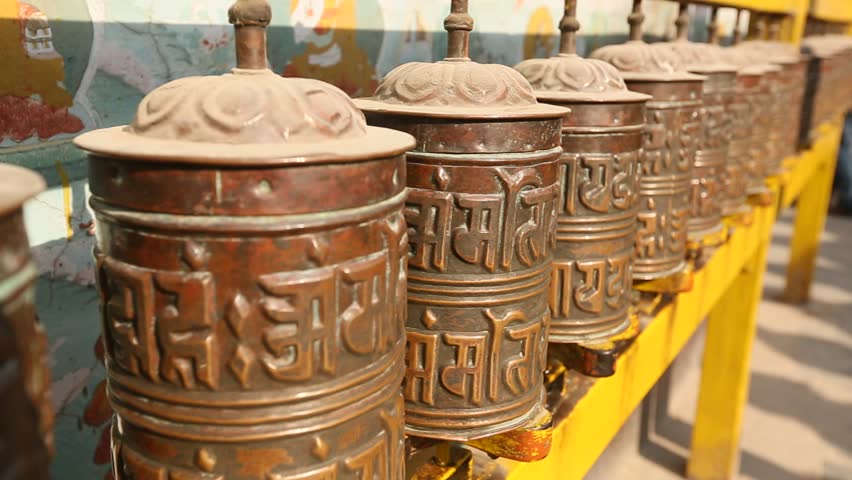 Spinning Tibetan Buddhist prayer wheels at Boudhanath stupa, Kathmandu, Nepal