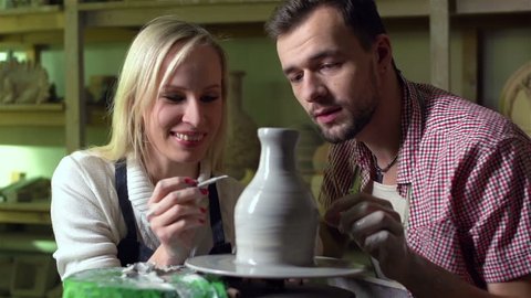 Young couple expressing their creativity in a pottery workshop