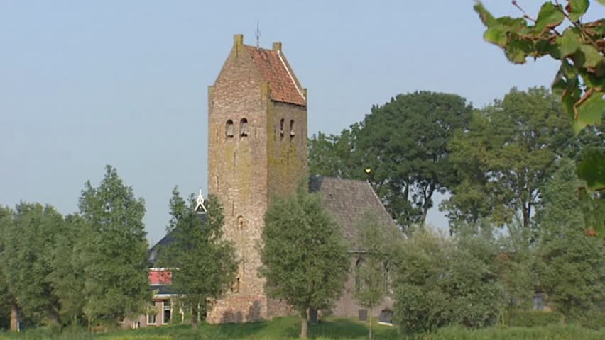 FRIESLAND, THE NETHERLANDS - AUGUST 2013: Terp with 14th century Church of Westhem. A terp is a hand-made hill which protected the Frisian people and their cattle against flooding 