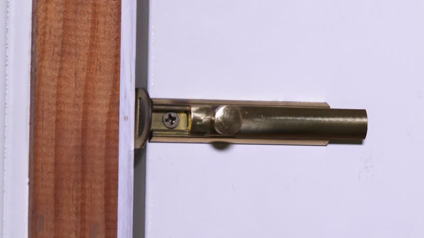 Locking and unlocking the deadbolt on a house's front door.