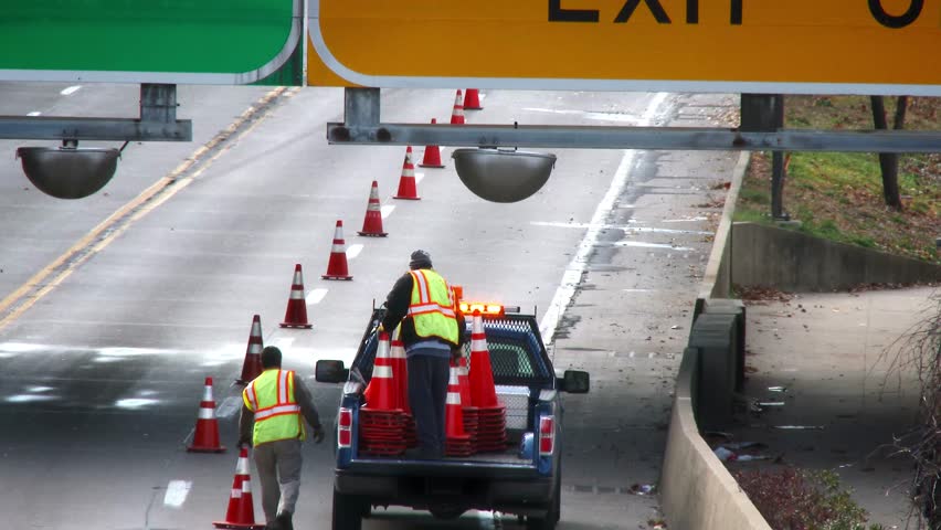 PITTSBURGH, PA - Circa November, 2013 - PennDOT workers remove safety cones from