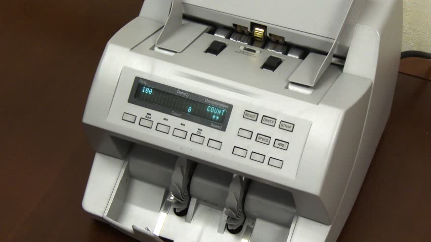 A money counting machine counts $10,000 in new $100 bills. In 4K UltraHD.