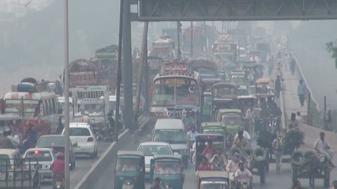 LAHORE, PAKISTAN - 25 OCTOBER 2010: Exhaust fumes and smog fill the air as busy traffic makes its way across a bridge in Lahore