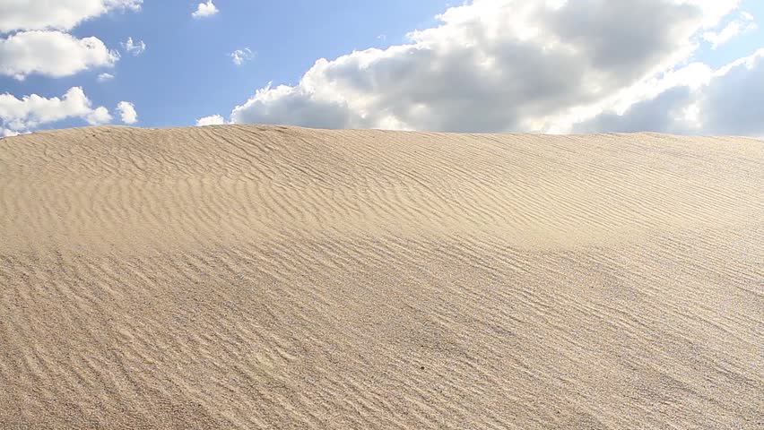 Dune against cloudy sky