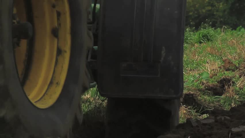 Close-up of plowing a field