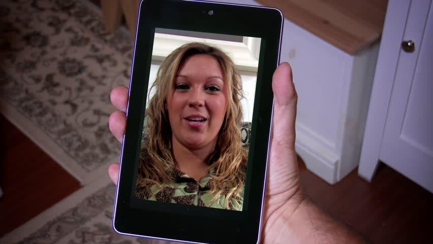 A woman videochats on a tablet PC. In 4K UltraHD.