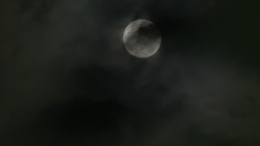 A timelapse shot of the full moon on a cloudy night. Not computer generated. In