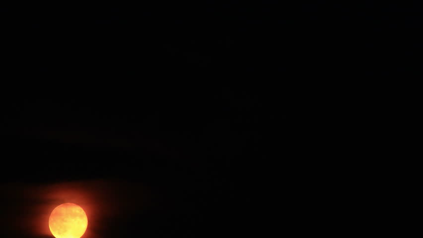 Moonrise 1. Bright orange moonrise through cloudy haze on a humid night, shot in