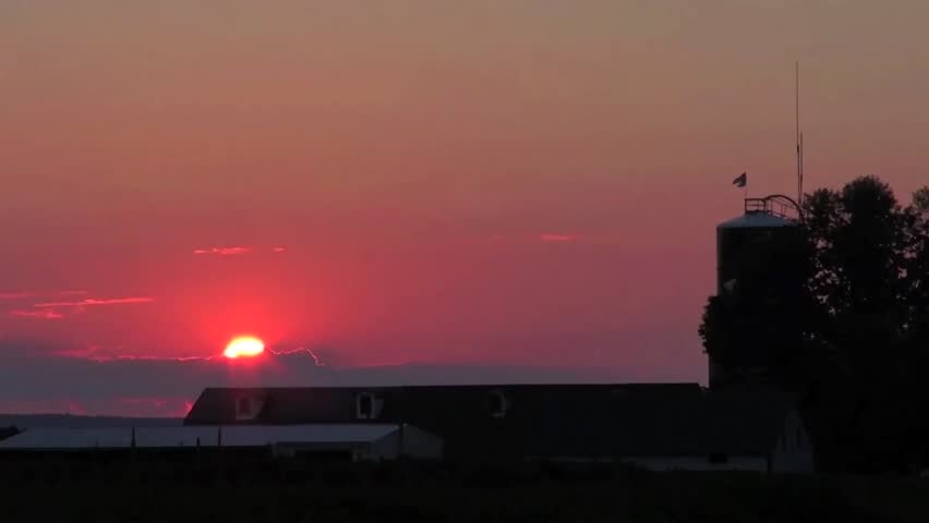 Time lapse sunset over a barn.