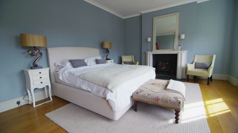 View of elegant bedroom in a stylish, classically designed home with a contemporary feel. No people.