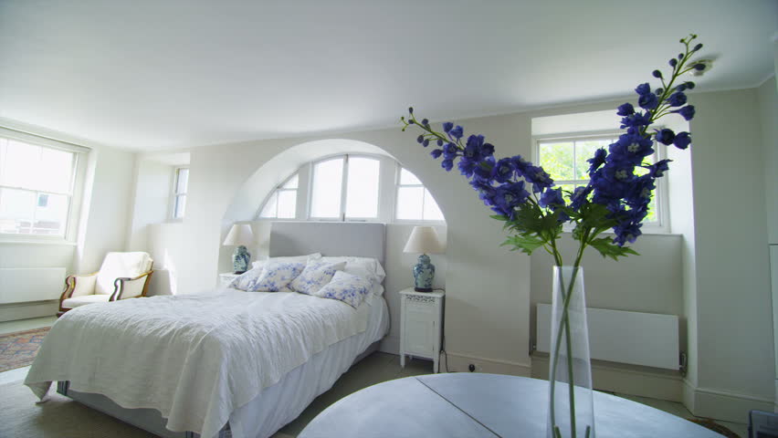 View of elegant bedroom in a stylish, classically designed home with a contemporary feel. No people.