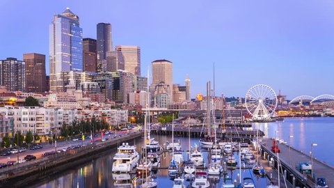 SEATTLE, WASHINGTON – SEPTEMBER 2: Time lapse of the sun setting on waterfront and marina in downtown Seattle, Washington on September 2, 2012.