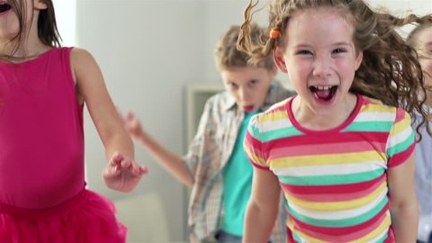 Close-up of children having pure fun jumping around, slow-motion