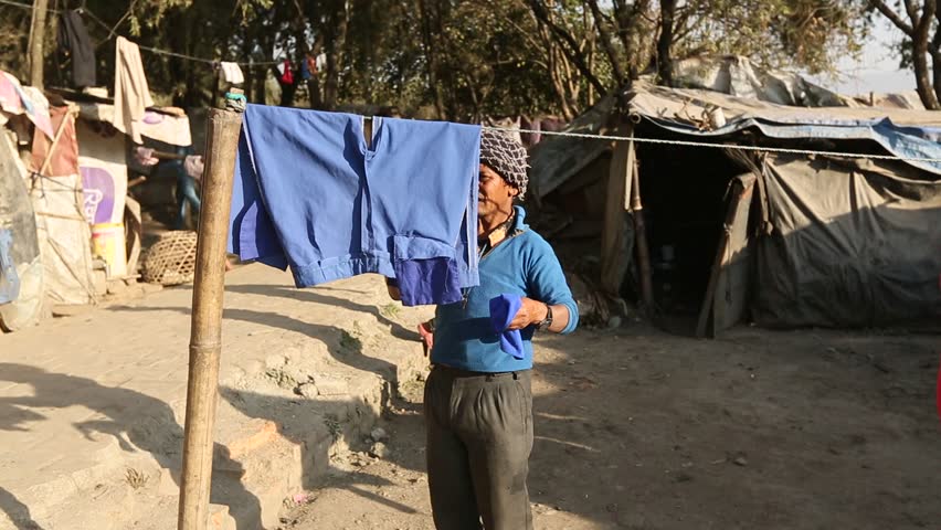 KATHMANDU, NEPAL - DEC 16: Unidentified poor people near their houses at slums