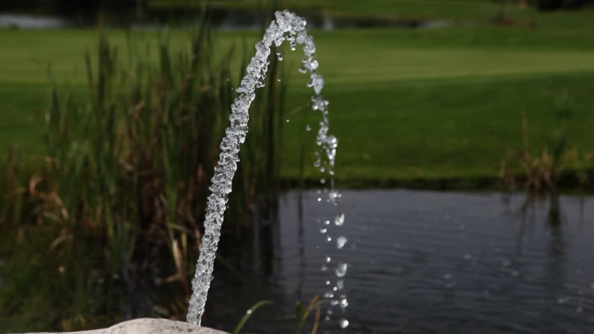 A water fountain on a golf course