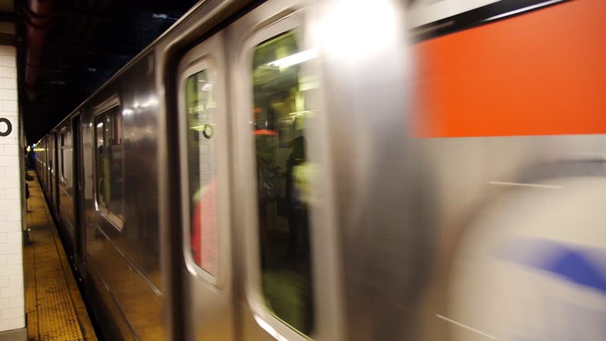 NEW YORK CITY - Circa December, 2013 - Passengers wait as a New York City subway