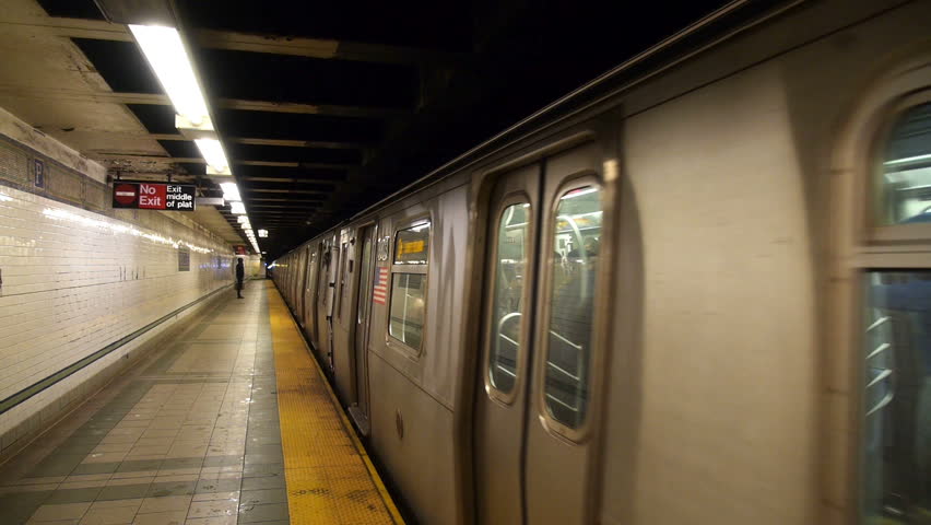 NEW YORK CITY - Circa December, 2013 - Passengers wait as a New York City subway