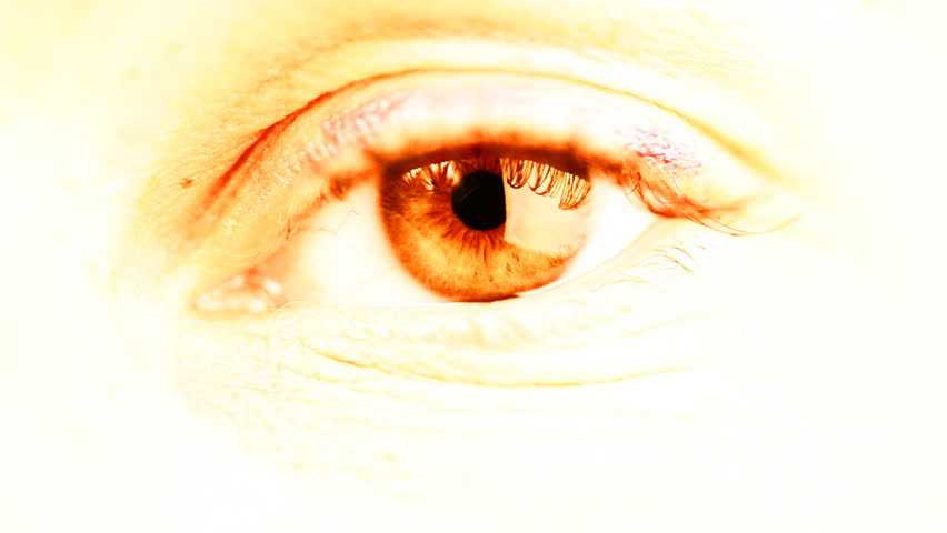 Female eye in glowing yellow