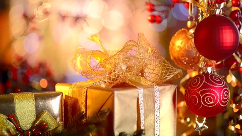 Christmas and New Year Gifts and Decoration. Abstract Blurred Bokeh Background. Gift Box and Baubles close up. HD Video Footage