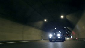 Beautiful low angle shot of Corvette C3 driving through tunnel at night