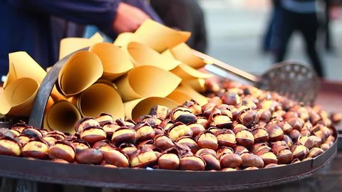 A beautiful shot of cooking and exposure chestnuts in christmas time. วิดีโอสต็อก