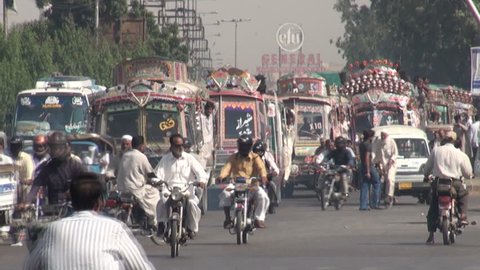 KARACHI, PAKISTAN - 26 OCTOBER 2010: Colorful buses and other traffic drive through the streets of Karachi, the largest city in Pakistan 