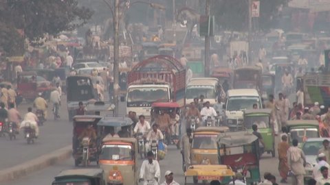 LAHORE, PAKISTAN - 24 OCTOBER 2010: Traffic drives through the streets of Lahore, leaving a trail of smog