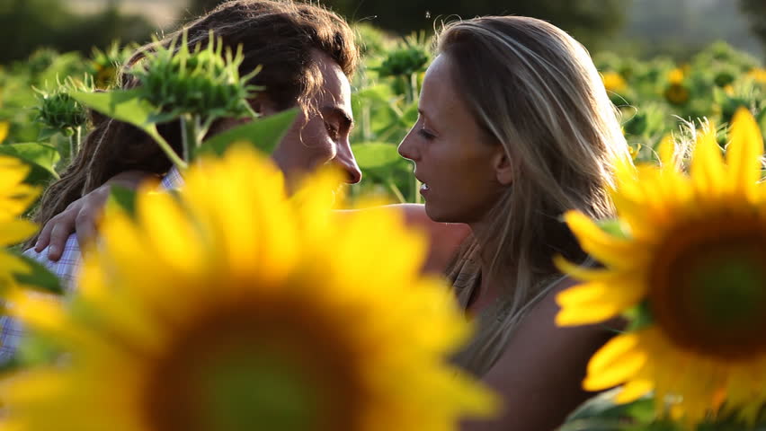 Couple in love surrounded by sunflowers