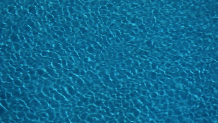 Sun reflections in pool water from above