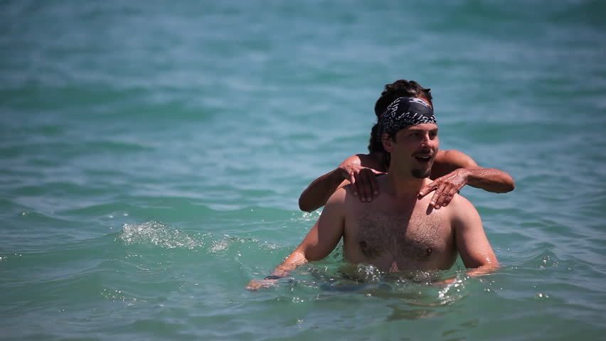 Two friends enjoying clear blue water of Mediterranean sea