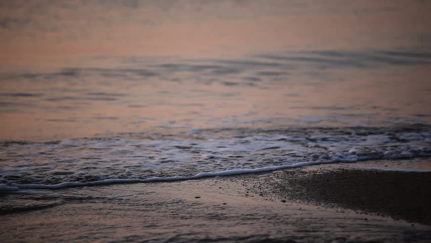 Water lapping on shore at dawn