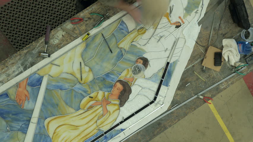 Time lapse of glass artist working on a stained glass window