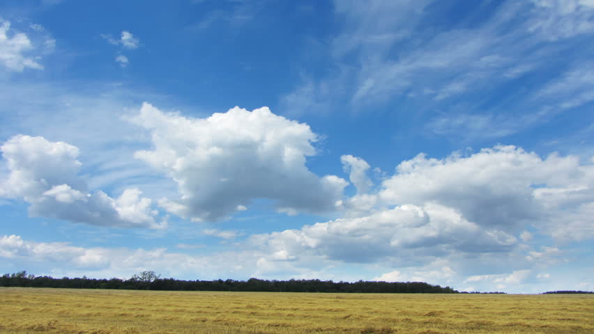 timelapse with clouds moving over yellow field
