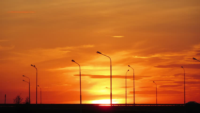 Cars silhouettes on road against sunset - timelapse 4k