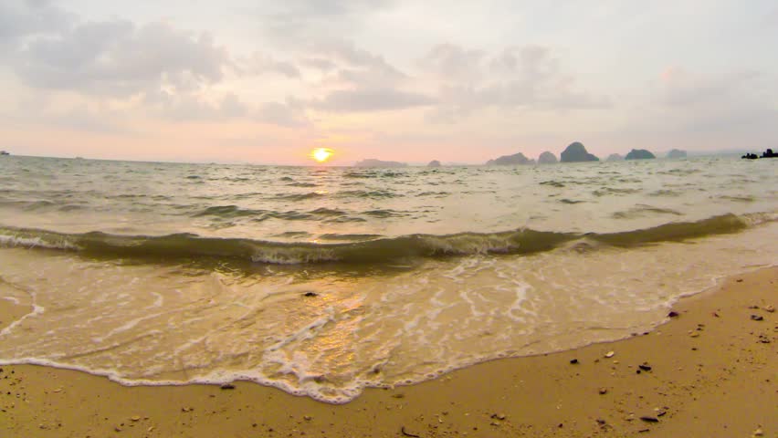 Timelapse. Sunset at Tup Kaek Sunset Beach, karst islands view. Krabi, Thailand.